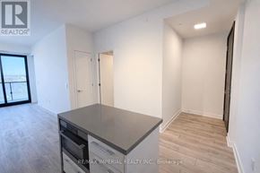 Toronto (Bayview Village) condo for rent - A spacious kitchen with a large island and wooden flooring.