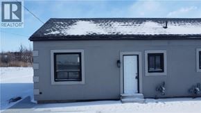 Hamilton apartment for rent - A house with a white door and windows is surrounded by snow.