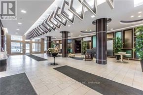 Toronto (Newtonbrook East) condo for rent - A lobby with a large marble floor and a black and white patterned ceiling.