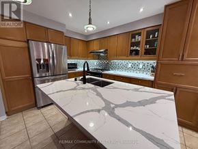 Ajax (Northeast Ajax) apartment for rent - A kitchen with a marble countertop and wooden cabinets.