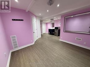 Ajax (Northeast Ajax) apartment for rent - A room with pink walls and a wooden floor.