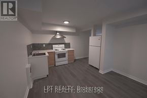 Ottawa apartment for rent - A kitchen with a refrigerator, oven, and sink.
