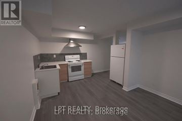 Ottawa apartment for rent - A kitchen with a refrigerator, oven, and sink.