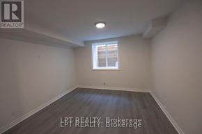 Ottawa apartment for rent - A room with a window and wooden flooring.