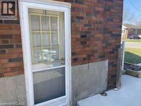 Hamilton apartment for rent - A window on a brick wall with a sign that says REALTOR above it.