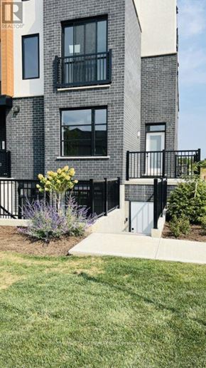 London South (South V) townhouse for rent - A modern building with a well-maintained lawn in front.