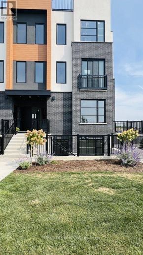 London South (South V) townhouse for rent - A modern building with a black fence and a small garden in front.