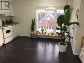 Markham (Cornell) apartment for rent - A kitchen with white appliances and a window with a view of a red building outside.