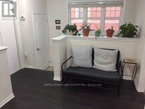 Markham (Cornell) apartment for rent - A black bench with white pillows sits in a room with a window.