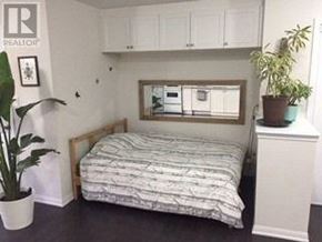 Markham (Cornell) apartment for rent - A bedroom with a bed, a mirror, and a plant.