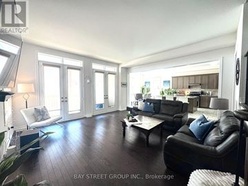 Innisfil (Lefroy) apartment for rent - A living room with a black leather couch and a wooden floor.