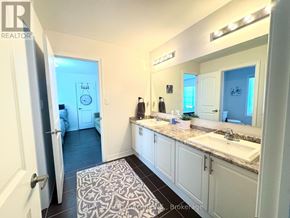 Innisfil (Lefroy) apartment for rent - A bathroom with a sink, mirror, and a rug on the floor.