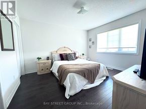 Innisfil (Lefroy) apartment for rent - A bedroom with a bed, nightstand, and dresser.