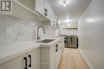 Markham (Middlefield) apartment for rent - A kitchen with white cabinets and a marble counter top.