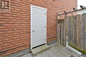 Markham (Middlefield) apartment for rent - A white door is on the left side of a brick wall.