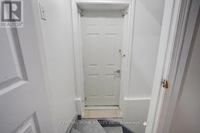 Markham (Middlefield) apartment for rent - A white door in a hallway with a brokerage sign on the bottom.