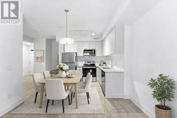 St. Catharines (E. Chester) townhouse for rent - A modern kitchen with a dining table set for four.