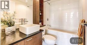 Vancouver apartment for rent - A modern bathroom with a white toilet and a bathtub.