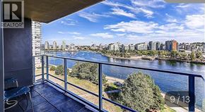 Vancouver apartment for rent - A balcony with a view of a river and buildings.
