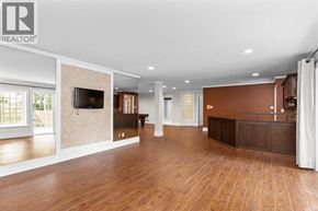 Vancouver apartment for rent - A spacious living room with wooden floors and a large television.