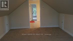 London East (East G) duplex for rent - A room with a carpeted floor and a doorway leading to another room.