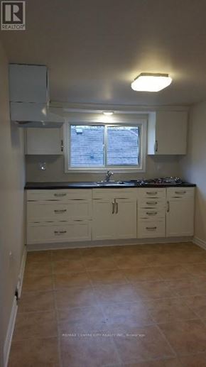 London East (East G) duplex for rent - A kitchen with white cabinets and a window.