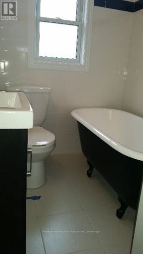 London East (East G) duplex for rent - A white toilet and sink in a small bathroom.