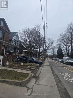 Toronto (Weston-Pellam Park) apartment for rent - A street with a bike lane and parked cars.