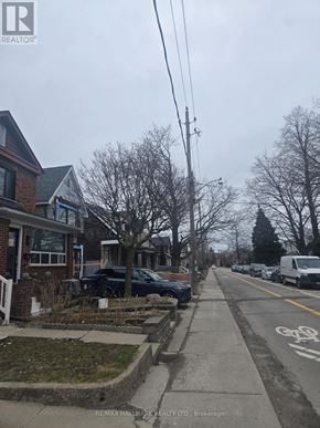 Toronto (Weston-Pellam Park) apartment for rent - A residential street with parked cars and a bike lane.