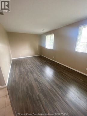 Windsor apartment for rent - A room with wooden flooring and two windows.