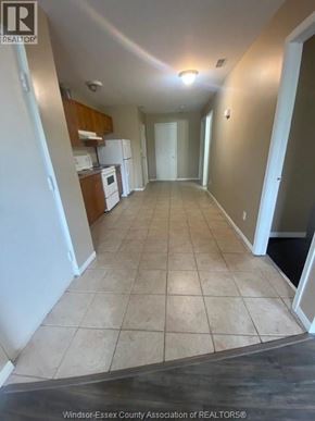 Windsor apartment for rent - A long hallway with tile flooring and white walls.