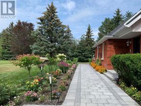 Aurora (Bayview Southeast) apartment for rent - A house with a well-maintained garden in front.