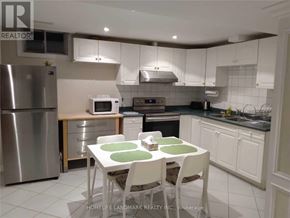 Vaughan (Islington Woods) apartment for rent - A kitchen with a table and chairs in front of it.