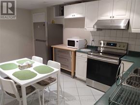 Vaughan (Islington Woods) apartment for rent - A kitchen with white cabinets and a green countertop.