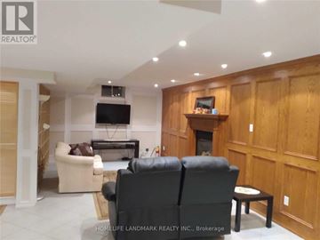 Vaughan (Islington Woods) apartment for rent - A living room with a black leather couch and a flat screen TV mounted on the wall.