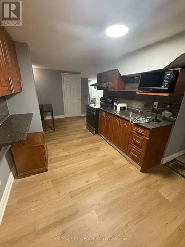 Markham (Middlefield) apartment for rent - A kitchen with wooden cabinets and a countertop.