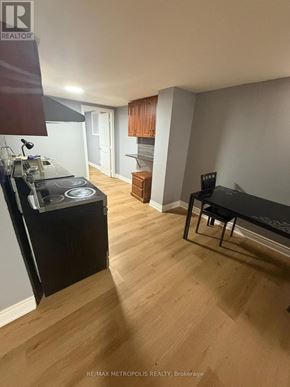 Markham (Middlefield) apartment for rent - A kitchen with a stove top oven and a black counter top.