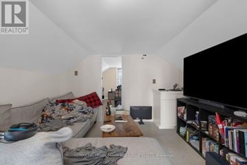 Barrie (Sanford) apartment for rent - A living room with a grey couch and a black television.