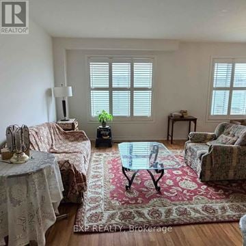 Toronto (West Humber-Clairville) townhouse for rent - A living room with a glass table and a rug in the middle.