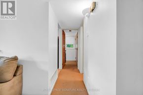 Waterloo townhouse for rent - A long hallway with a door at the end.