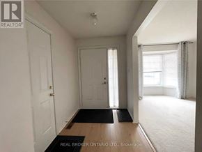 Niagara Falls (West Wood) apartment for rent - A hallway with a black doormat in front of a white door.