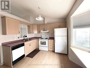 Niagara Falls (West Wood) apartment for rent - A kitchen with a white refrigerator, a white stove, and a white dishwasher.