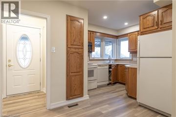 Hamilton apartment for rent - A kitchen with wooden cabinets and a white refrigerator.