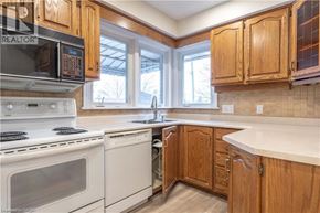 Hamilton apartment for rent - A kitchen with wooden cabinets and white appliances.