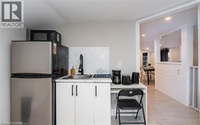 Hamilton apartment for rent - A kitchen with a refrigerator, microwave, and a sink.