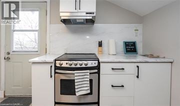 Hamilton apartment for rent - A white kitchen with a stove and oven.