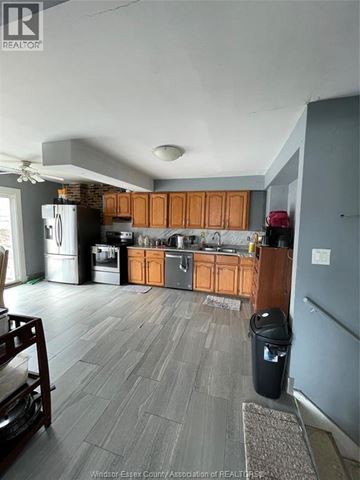 Windsor apartment for rent - A kitchen with wooden cabinets and a black trash can.