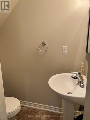 Toronto (Newtonbrook West) townhouse for rent - A white toilet sits next to a white sink in a small bathroom.