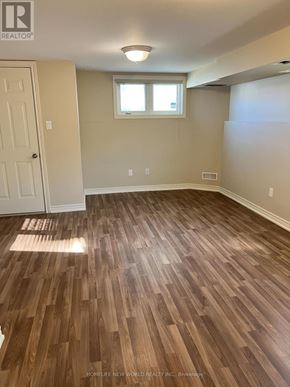 Toronto (Newtonbrook West) townhouse for rent - A room with wooden flooring and a window.