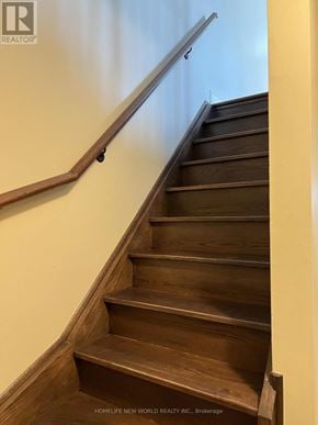 Toronto (Newtonbrook West) townhouse for rent - A wooden staircase with a metal handrail.